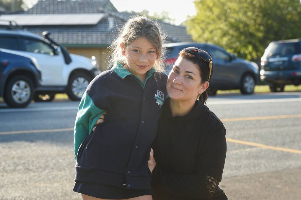 Shania Gale, 8 and mum Tarra, on their way to Melrose Primary School. Ms Gale is worried the early school holidays will lead to long-term shut-downs. Picture: MARK JESSER
