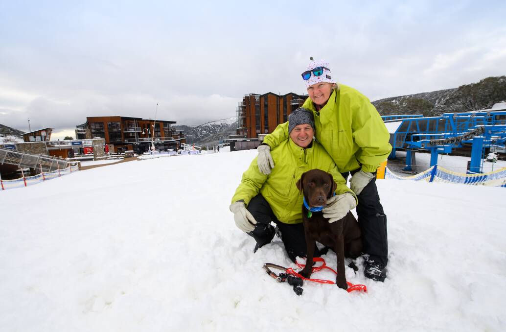 OPEN: The Victorian ski season is officially open, with Douglas Zollo, Noreen Prosser and dog Gidget being excited for what's to come. Pictures: MARK JESSER