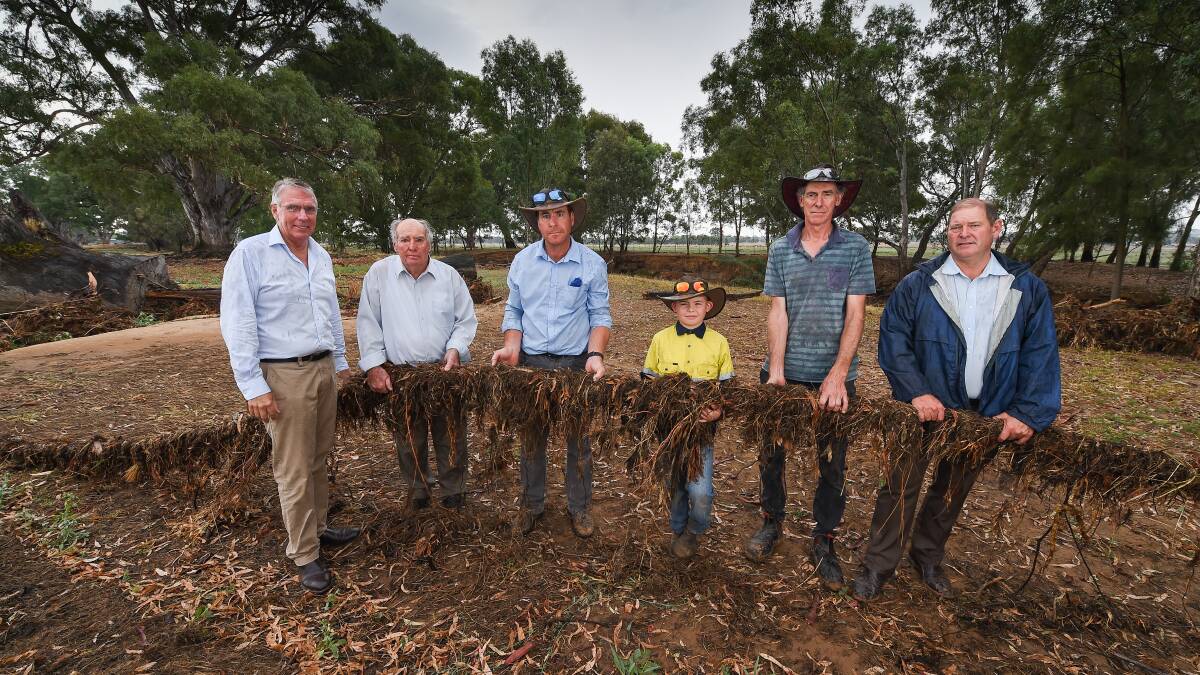 PUSHING THROUGH: John, Trevor, Liam, 8, and Russell of the Bennett family inspect damaged fencing at their Everton property. They were visited by Nationals leader Peter Walsh (left) and Ovens Valley MP Tim McCurdy (right) Picture: MARK JESSER