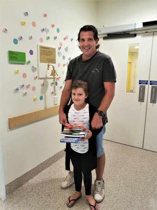 END IN SIGHT: Howlong's Tim Holmes was with his daughter Charlotte, 8, at the Royal Children's Hospital in Melbourne last week where she rung the "end of treatment" bell. 