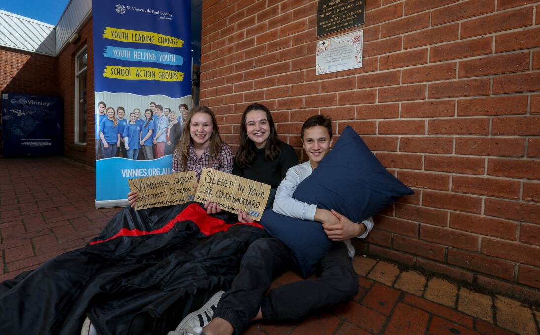 GESTURE: Milla Nichol, 14, Greta McAlister, 16 and Michael Patino, 16, are joining their families in the NSW Vinnies Community Sleep-out. They'll be sleeping in their backyards on Friday. Picture: TARA TREWHELLA