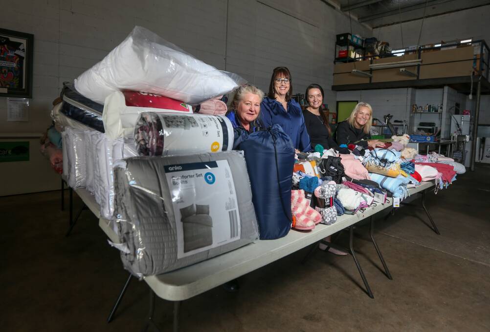 GROUP EFFORT: Stateguard security officer Cheryl McIntyre, Carevan director Jacqui Partington, West End marketing manager Nicole Singh and Carevan's Leanne Johnson with goods donated to a joint appeal. Picture: TARA TREWHELLA