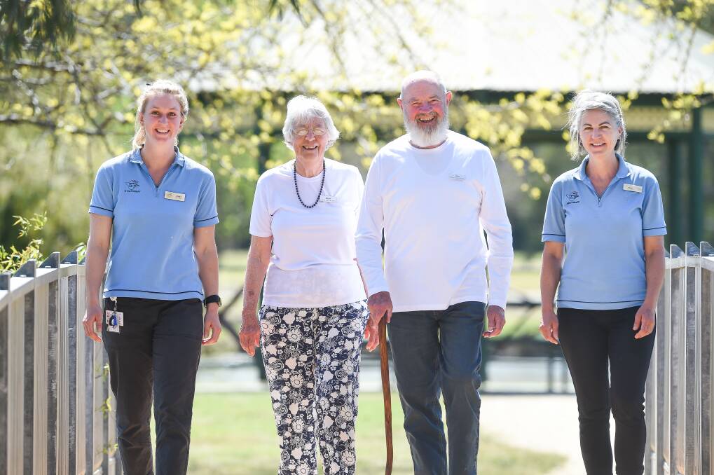 STEP UP: Joan and Jon O'Neill (middle) are walking for Parkinson's awareness on Sunday and are supported by Albury Wodonga Health staff Jess Fisher-Curnow and Elissa Schliebs. The couple join a walking group at Sumsion Gardens. Picture: MARK JESSER
