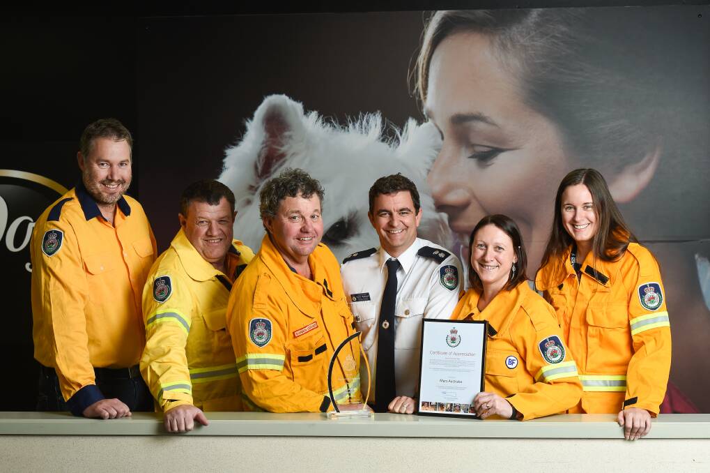 TEAM: RFS volunteers Nathan Cooper, John Townsend and Darren Gugger are congratulated by Pat Westwood with their fellow members Lisa Wilkie and Natasha Hedrick. Mars has won a supportive employer award. Picture: MARK JESSER
