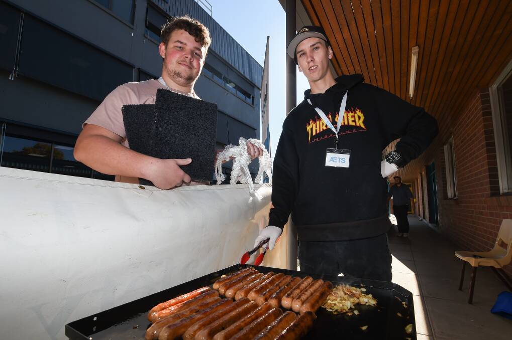 GOOD CAUSE: Baden Saul and Sam Robinson are among the PaTH participants who have made items for the Albury Wodonga Animal Rescue. The group of eight working with AETS have raised more than $250. Picture: MARK JESSER