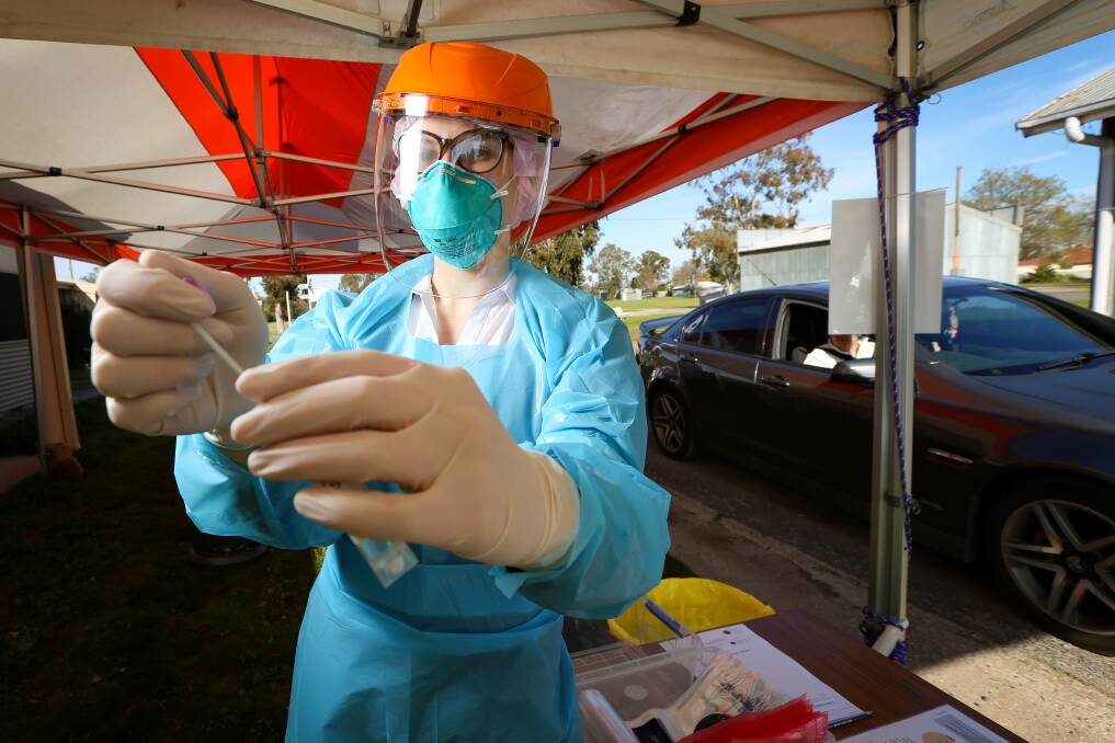 EASY ACCESS: Douglass Hanly Moir Pathology has taken over the COVID-19 testing clinic at Albury showgrounds, and is operating a drive-through rather than a walk-in system. Hayley Gardner prepares to conduct a swab for COVID-19 on Tuesday. Picture: JAMES WILTSHIRE