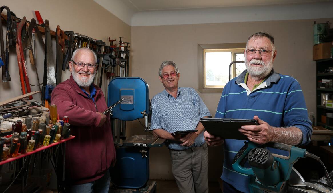 TUNING IN: The Henty Men's Shed is among the community groups using iPads to connect, with Tony O'Brien, John Ebsworth and Neil Meyer having a trial run recently. Picture: JAMES WILTSHIRE