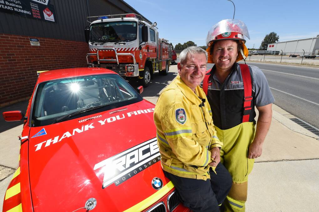 MESSAGE: Thurgoona RFS Senior Deputy Captain Ross Wilson was stoked that mate Mark Tracey was going to wrap his BMW with a thank you message for firefighters. Picture: MARK JESSER