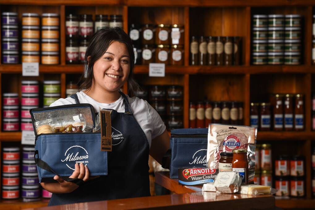 ALL YOU NEED: Milawa Cheese Company employee Bec Bunny puts together an 'isolation pack'. Delivery is now the way to reach customers, after 22 years of visitors flocking to the historic Milawa Butter Factory. Picture: MARK JESSER