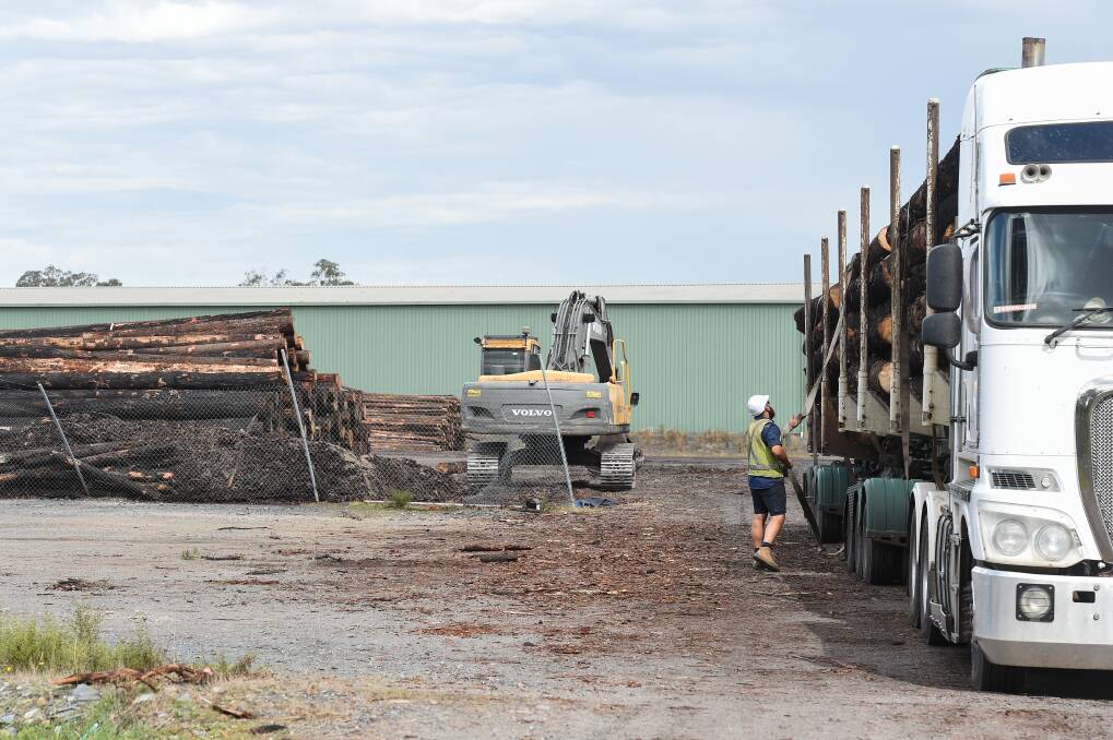 DELIVERY: A truck driver delivers a load of timber to a facility in Holbrook. Timber mills across the region are busy processing salvaged burnt timber. Picture: MARK JESSER