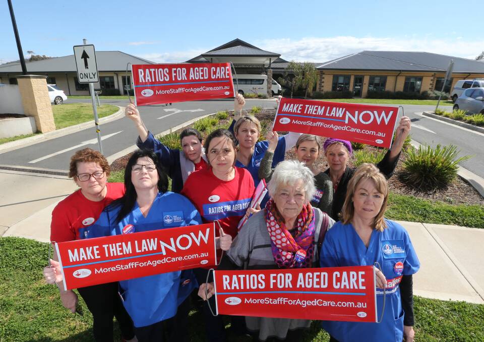 MAKE CHANGE: Nurses and union members Zoe Guinea, Catherine Winchester, Libby Boulding, Viola Morris, Gillian Rhodes, Geraldine Chapman, Bianca Gallo, Fiona Bradley, and Carol Leslie protest for ratios to be legislated at the Albury and District aged care home. Picture: KYLIE ESLER