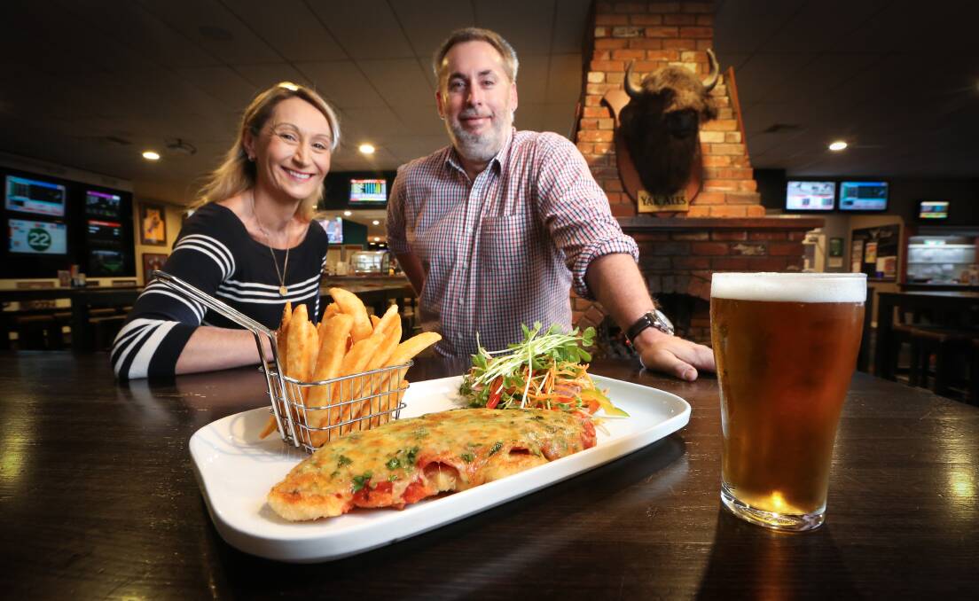 TUCK IN: Blazing Stump Hotel managers Jo Morley and Michael Horsell eye off a parma, with $1 from every one sold supporting drought relief. Picture: KYLIE ESLER