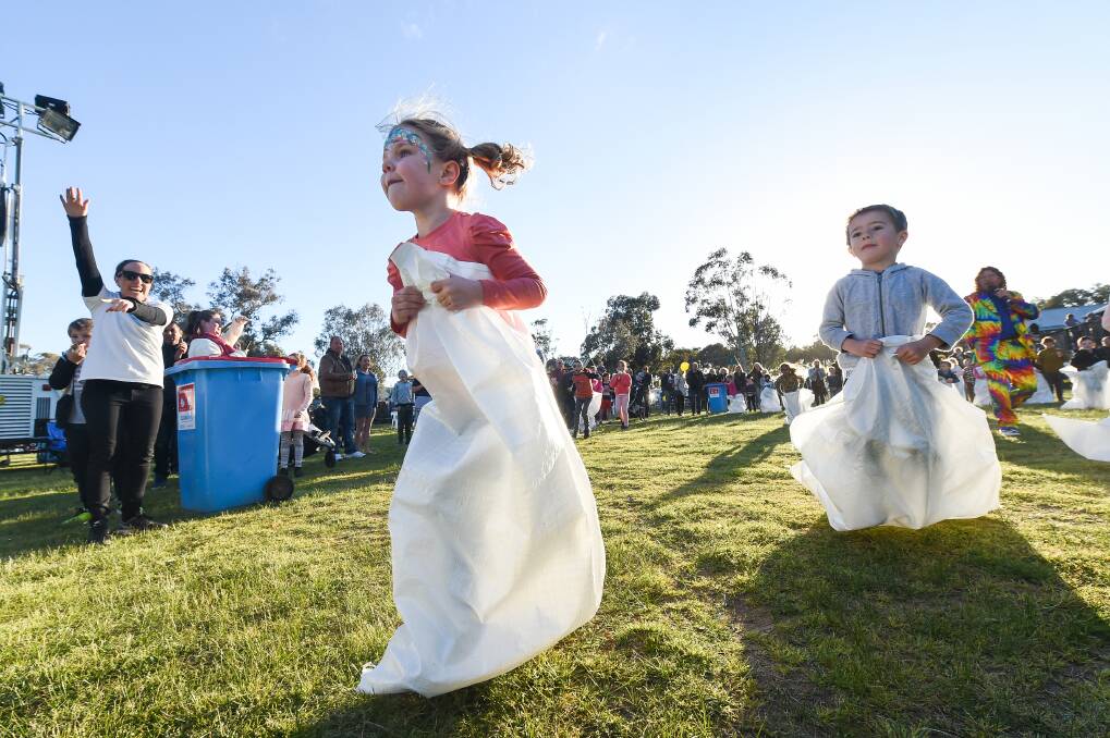KID'S DREAM: Scarlet Lattenstein, 5, and Brock Craze, 5, go head-to-head in a sack race at a family fun day as part of Sunshine Week, supporting the Border's cancer centre, at the Kinross Woolshed in Thurgoona. Picture: MARK JESSER