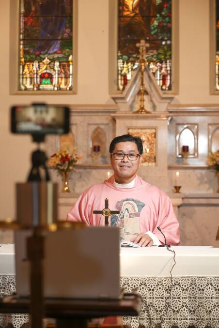  TUNE IN: Father Junjun Amaya holds Sunday mass via Facebook at the Saint Augustine's Church in Wodonga, following advice from the Bishops of Victoria. Picture: JAMES WILTSHIRE