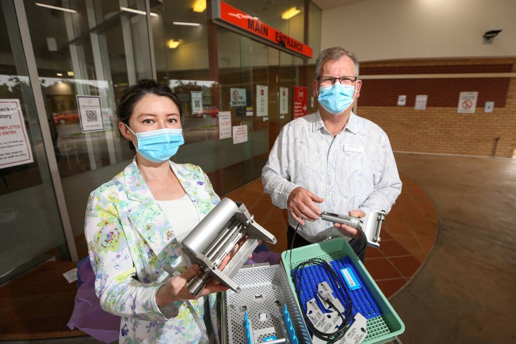 NEW GEAR: Dr Queenie Chan with new equipment, donated by the Albury Wodonga Regional Cancer Centre Trust, represented by Bryan Blake. Picture: JAMES WILTSHIRE