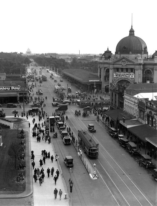 Melbourne's busiest intersection, the corner of Flinders Street and Swanston Street. In amongst the motor vehicles, trucks and trams are horse-drawn carts. Swanston Street crosses Princes Bridge to become St Kilda Road. In the middle distance is the Shrine of Remembrance. The banner on Buffalo reads "There's magic in the springtime air at Mt Buffalo National Park".
PICTURE: H. H. FISHWICK, Fairfax Photographic