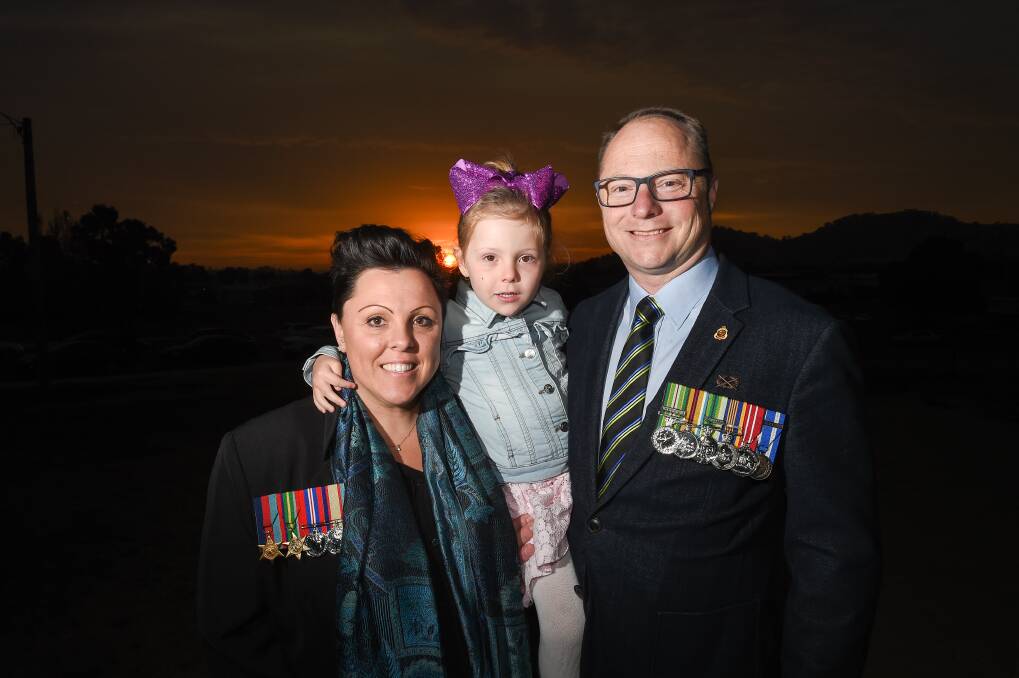 GENERATIONAL: Carly and Damien Batty with their daughter Eva, 4, at Wodonga RSL sub-branch after the Dawn Service. Picture: MARK JESSER