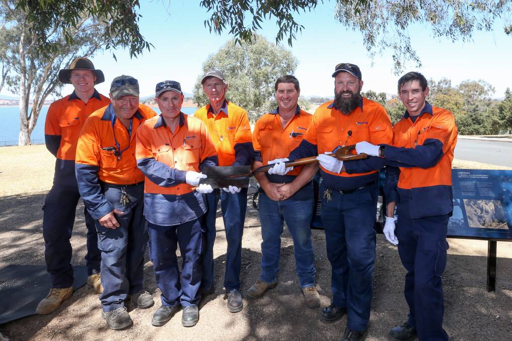 WaterNSW employees hold the shovel used to turn the first sod for the construction of the Hume Dam. Picture: TARA TREWHELLA