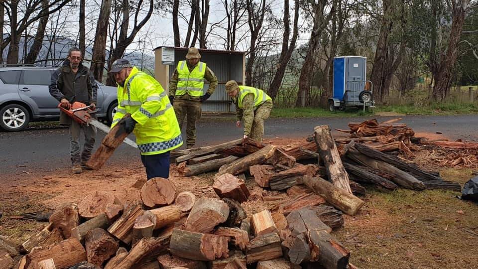 SUPPORT: Jingellic local Noel McDonell has provided a log-splitter for police and ADF members to use at his local checkpoint. Picture: NSW POLICE