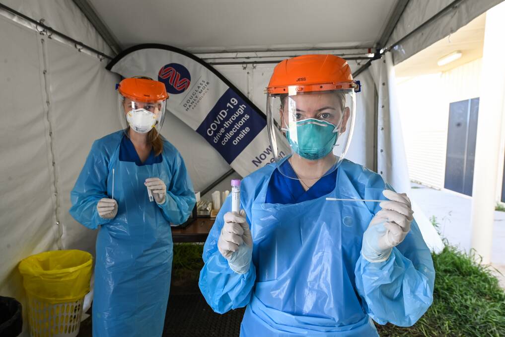 SWAB: Tanisha Melmoth and Jessica Hooper on deck at the Douglass Hanly Moir Pathology Albury showgrounds drive-through clinic. Picture: MARK JESSER
