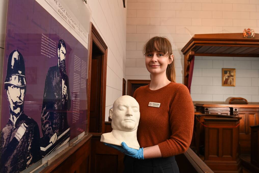 LIVE IT: Ned Kelly's death mask, held by Ashleigh Giffney, will be among the artefacts complementing Indigo Shire's Kelly Trials project at the Beechworth Historic Court House. Picture: MARK JESSER