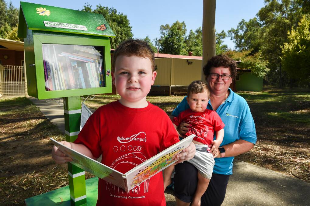 OPEN: Lewis Griffiths, 4, with Jasper Smylie, 1, and educator Margie Sandford at Kids on Campus' street library at TAFE. Picture: MARK JESSER