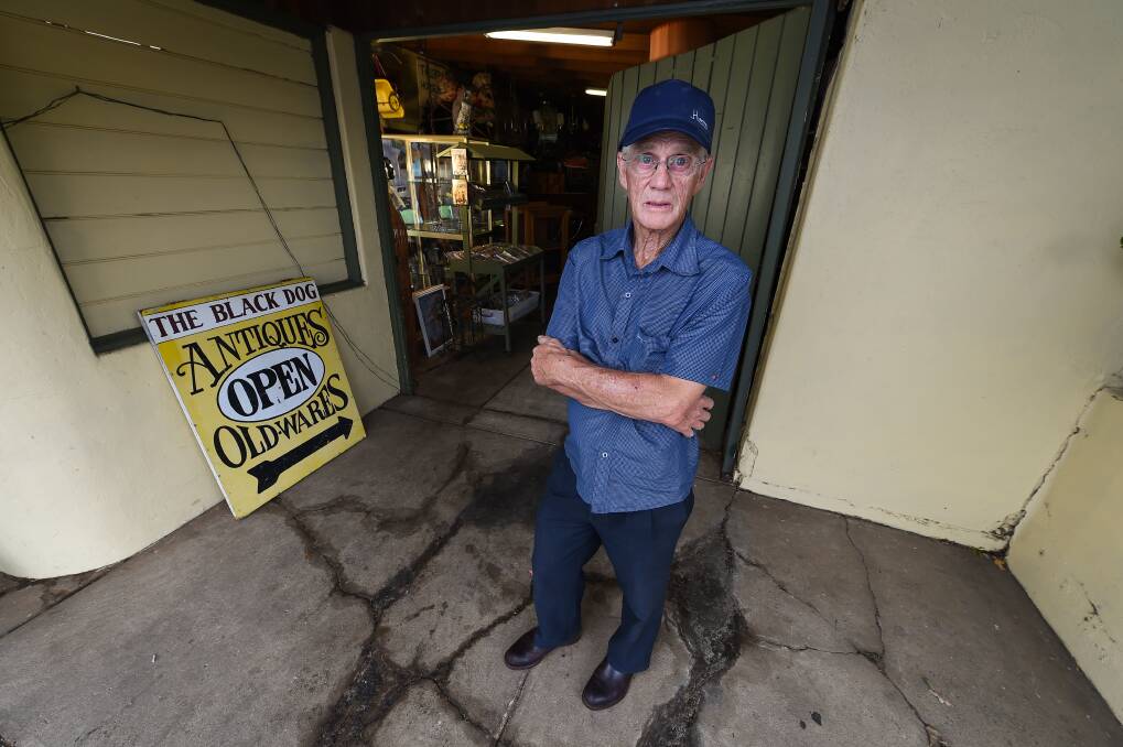 Leigh Shannon, owner of The Black Dog Antiques stands in front of his shop, where the water is coming up from the ground and the wall is sagging away from the door. Picture: MARK JESSER