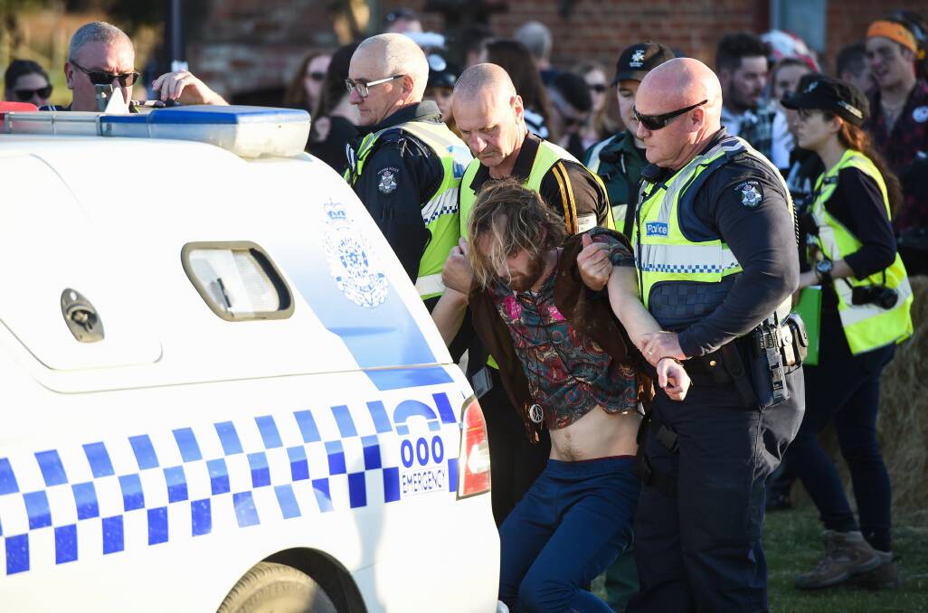 DRUNK: Police arrest a 34-year-old man at the Winery Walkabout for being drunk in public. Overall, crowds were well-behaved. Picture: MARK JESSER