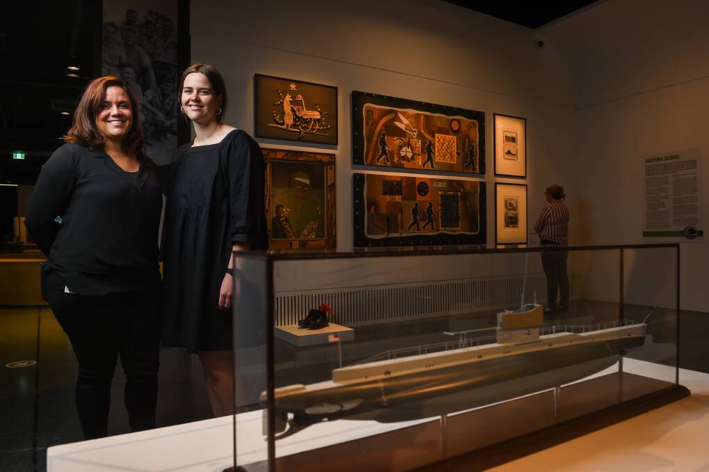 Curators Andrea Briggs and Bethany Thornber are pictured in front of Dr Treahna Hamm's artworks. Picture: MARK JESSER