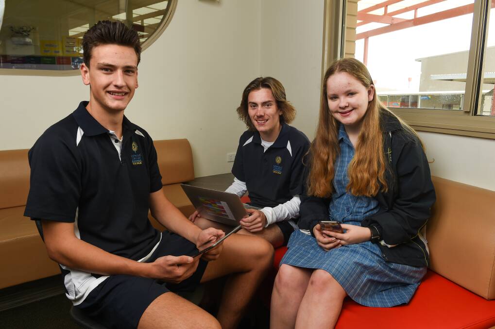 HELPERS: Catholic College Wodonga students Rhys Venturoni, 16, Mitch Damm, 17, and Rebecca van der Veeke, 16, are taking part in a class where they assist community members with technology. Picture: MARK JESSER