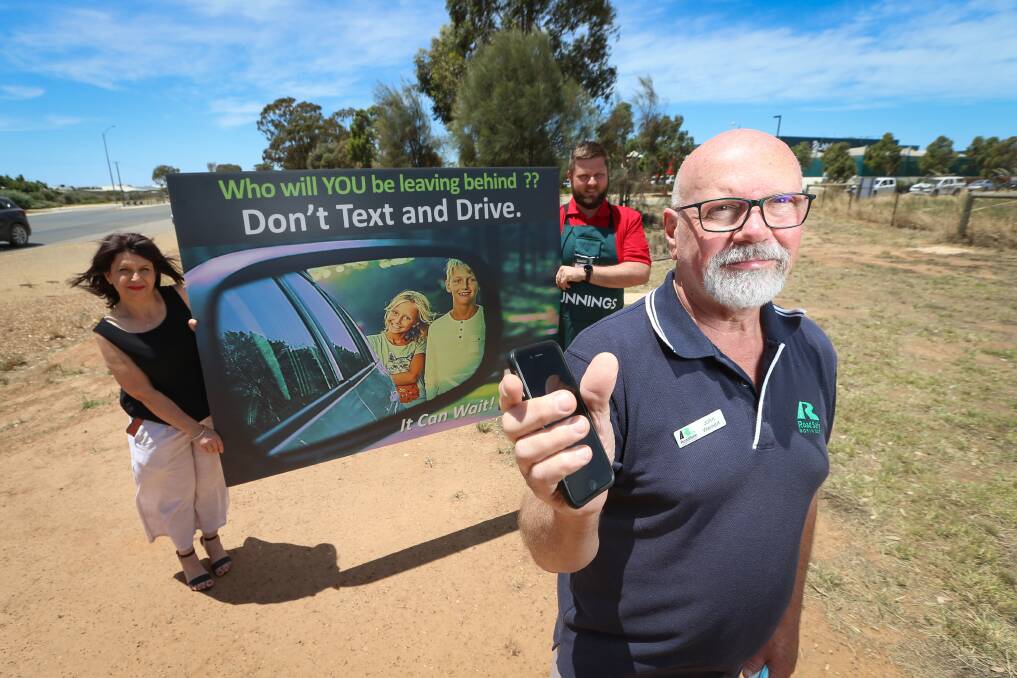 CLEAR CALL: Road Safe North East's Mary Vescio and John Weinert have led a campaign to stop drivers' phone use, with the support of Bunnings Yarrawonga and assistant store manager Dan Mitchell. Picture: JAMES WILTSHIRE