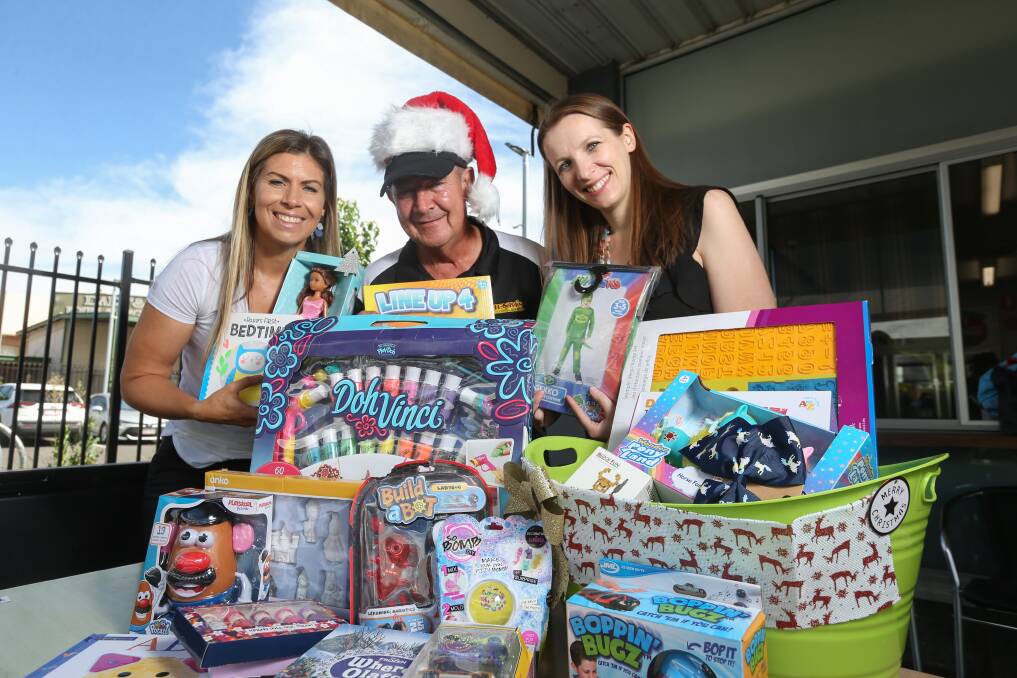 JOINT EFFORT: Junction Support Services' Annie Shirley has recruited father-in-law Ian to host a drop-off point for Junction's toy drive at his bakery, Henri's. Junction staff like Rhianna Jones have seen big demand for support this year. Picture: TARA TREWHELLA