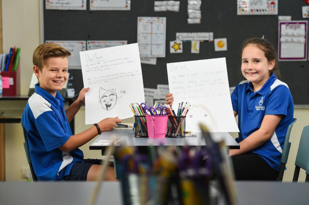 SHARING: Yackandandah Primary students Nate Attwood, 9, and Saige Harmer, 8, enjoyed writing letters to residents. Picture: MARK JESSER
