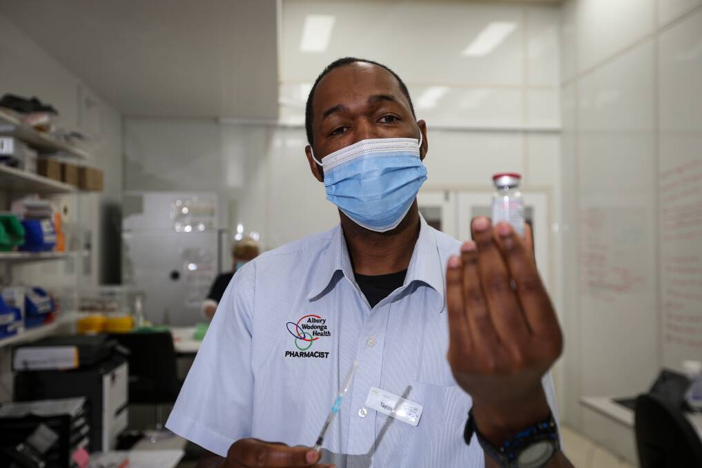 Albury Wodonga Health Pharmacist Tapps Rusike preparing vaccines for the day. Picture: James Wiltshire 