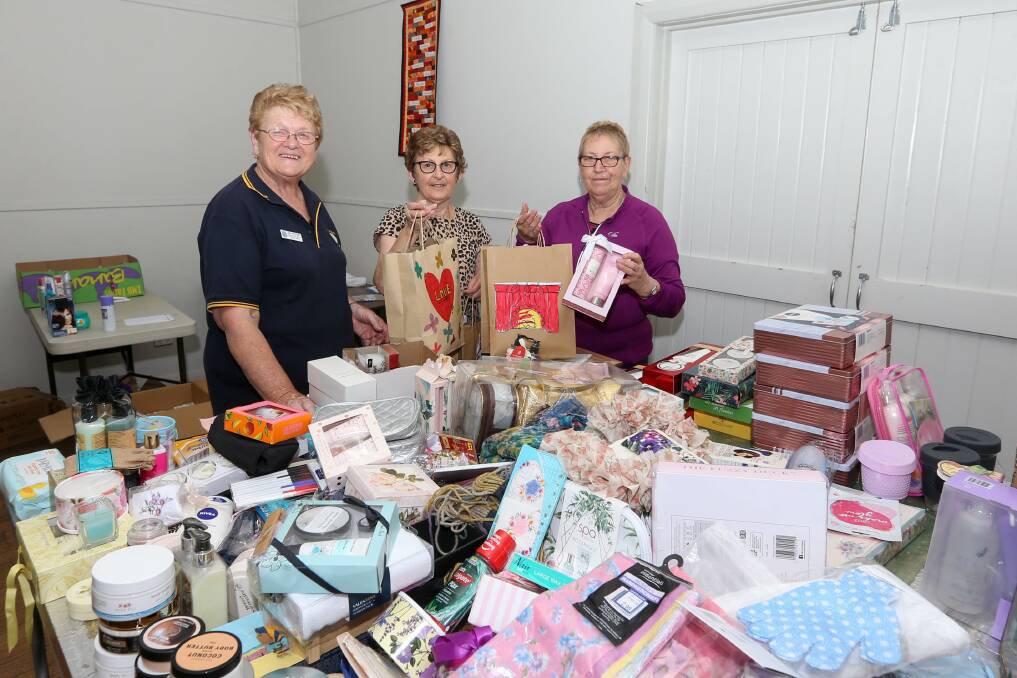 HANDS ON DECK: Bev Frohling, Heather Barrett and Susan Campbell were among the volunteers from Lions Clubs and CWA branches assembling pamper packs for women living in drought. Picture: TARA TREWHELLA
