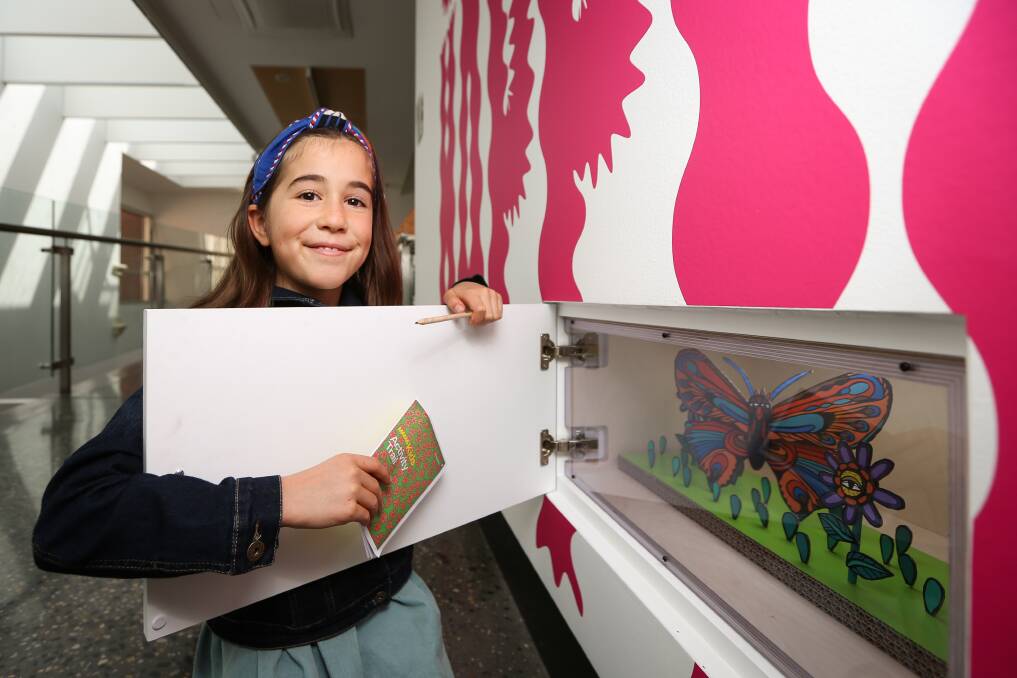 CHALLENGE: Audrey Falcke, 9, finds one of the 'wonder cupboards' at MAMA, as part of a free kids' activity trail. Picture: JAMES WILTSHIRE