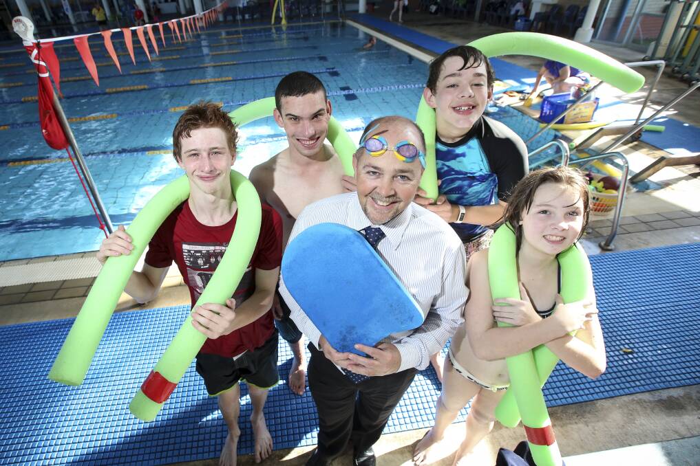 BACK: Belvoir Special School students Tim Gillam, 17, Cory White, 18, Jeremy Adams, 17, and Matilda Stanton, 13, are back in the water thanks to the YMCA Swimathon, but principal Jamie Gay will stay poolside. Picture: JAMES WILTSHIRE