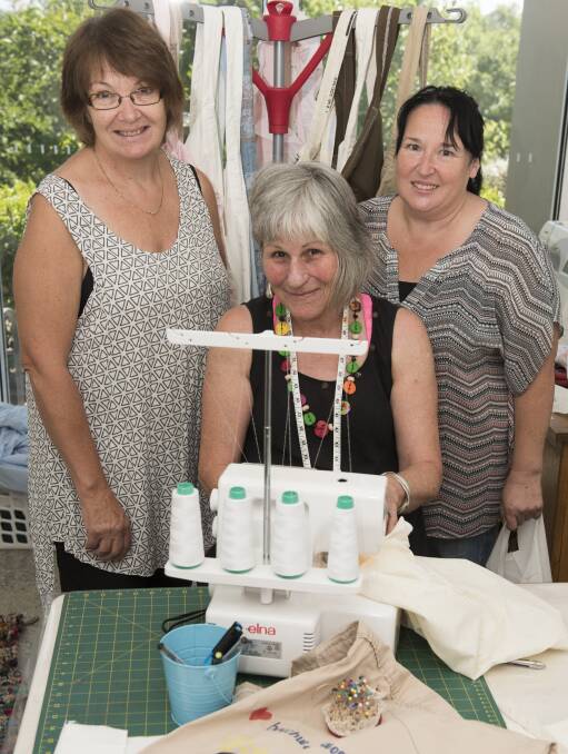 FRESH IDEA: Faye Gilbey, Margy Barwood and Barbara Brown working on the Beechworth Women's Shed's first project, reusable bags. Picture: SIMON BAYLISS