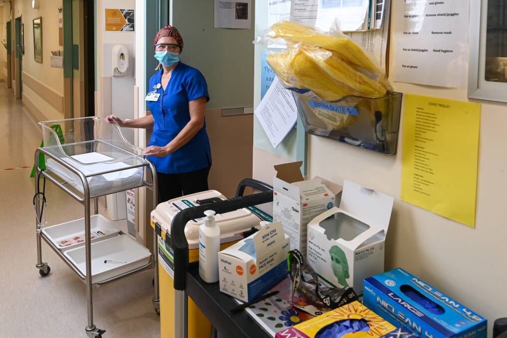SUPPORT IS THERE: Albury Wodonga Health midwife Deborah Birrell with some of the specialist COVID-19 equipment available if it were ever needed in Wodonga maternity. Pictures: MARK JESSER