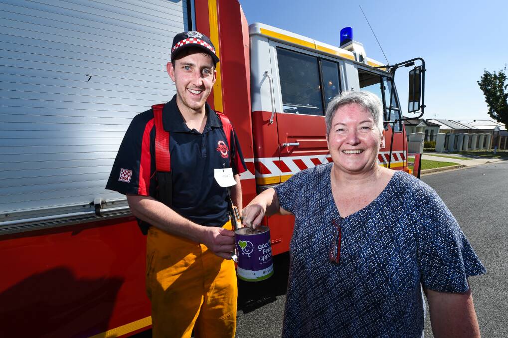 WELCOME SUPPORT: Volunteer Darcy McFarland receives a donation for the Royal Children's Hospital from Jenny Wood on Good Friday. Picture: MARK JESSER