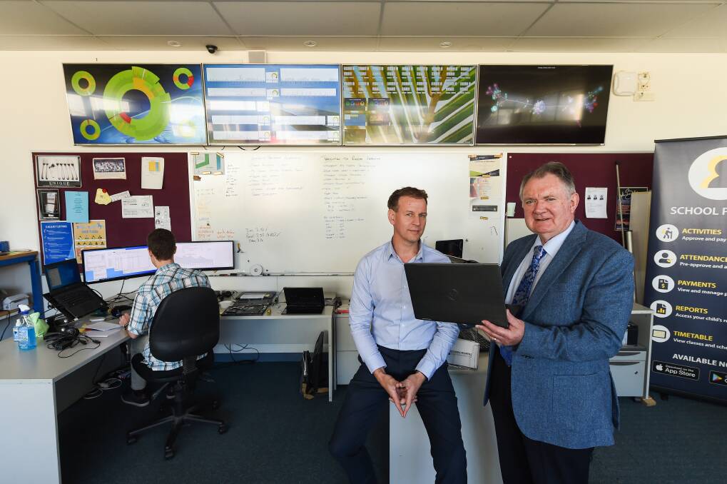 SUCCESS: Wodonga Senior Secondary College ICT manager Tim Bennetts and principal Vern Hilditch are pleased with a trial of online learning. Picture: MARK JESSER