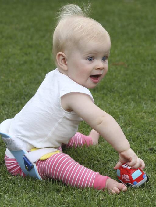 ALL SMILES: Ten-month-old Maggie Hayes, diagnosed with developmental dysplasia of the hip, must wear a brace 23 hours a day for her hip growth. Picture: ELENOR TEDENBORG