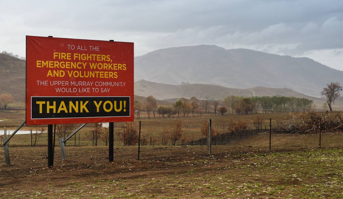 A sign thanks the brave efforts of firefighers, emergency workers and volunteers near Corryong. Picture: MARK JESSER