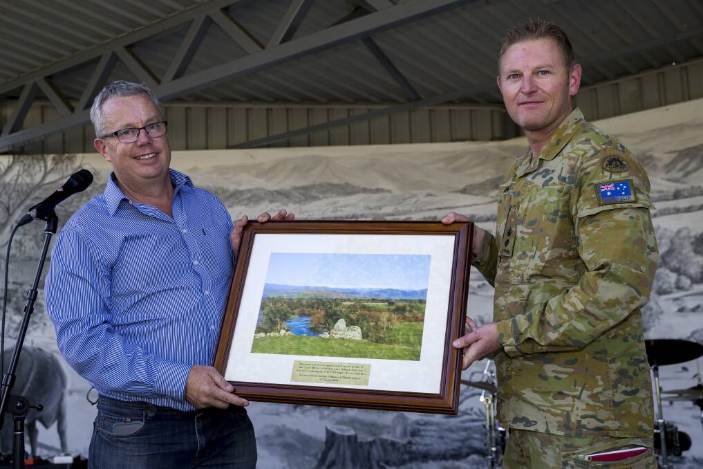 Deputy Mayor of Towong Shire, Councillor Andrew Whitehead presents a gift from the people of Corryong to Commander Joint Task Force 646.7 Lieutenant Colonel Colin Lingo at a thank you event. Picture: KIEREN WHITELEY/DEFENCE MEDIA