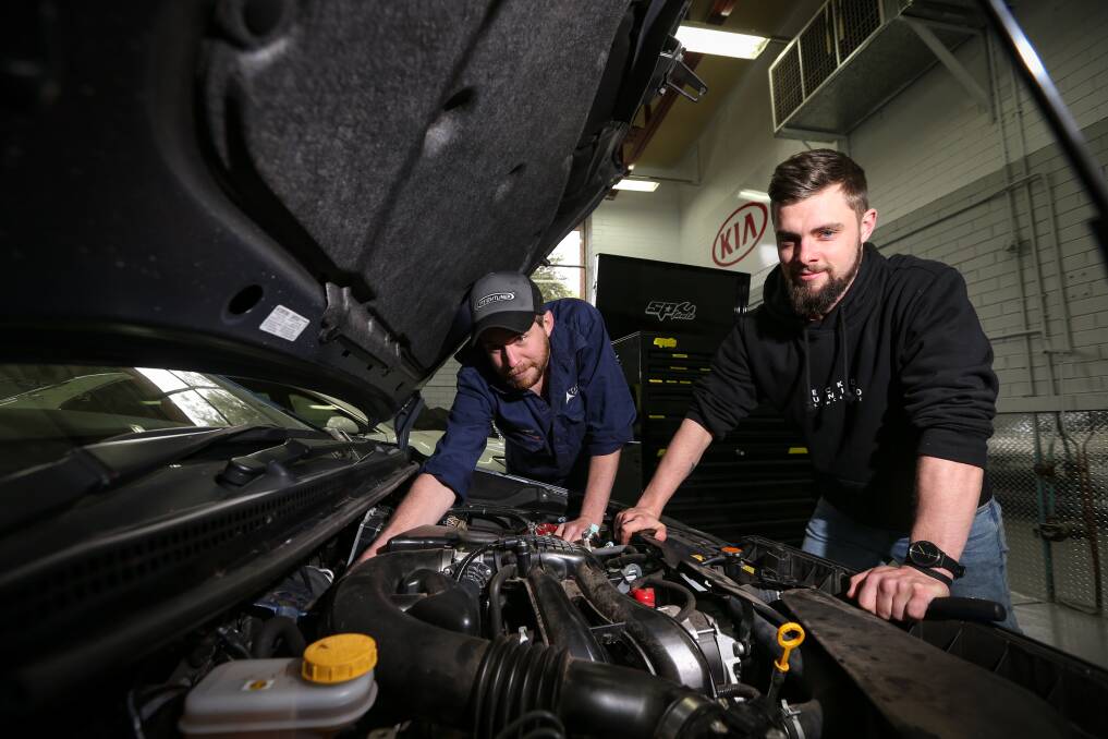 ADDITION: Qualified Albury TAFE automotive students Joel Barber and Hayden Keatings inspect a car donated by general insurer IAG. The hail-damaged Subaru is being used to teach students. Picture: JAMES WILTSHIRE