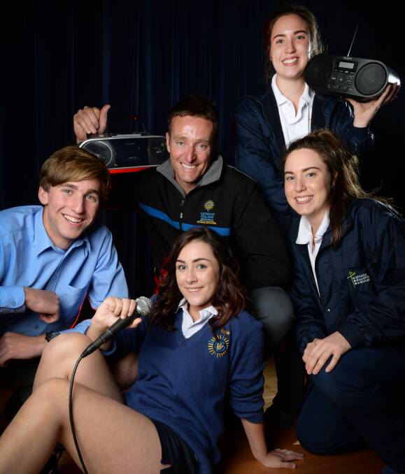 BIG NEWS: Wodonga Catholic College teacher Aaron West with year 10 students Rory Quinn, Alexia Brown, Lily Allan and Shai Allan, all 16, are excited Hamish and Andy will be attending the year 10 formal. Picture: MARK JESSER
