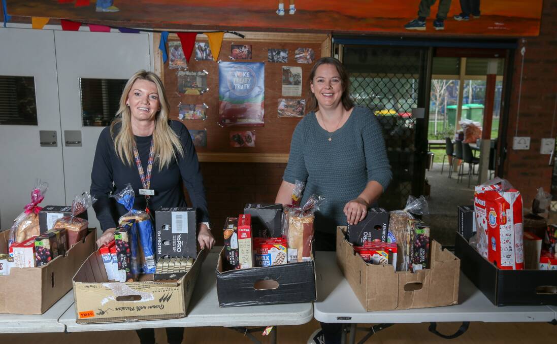 HELP: Stacey Franklin and Tracy Zani assemble and deliver food packs on Wednesdays at the Westside Community Centre. The centre is among the support agencies linked up to a new food relief line. Picture: TARA TREWHELLA