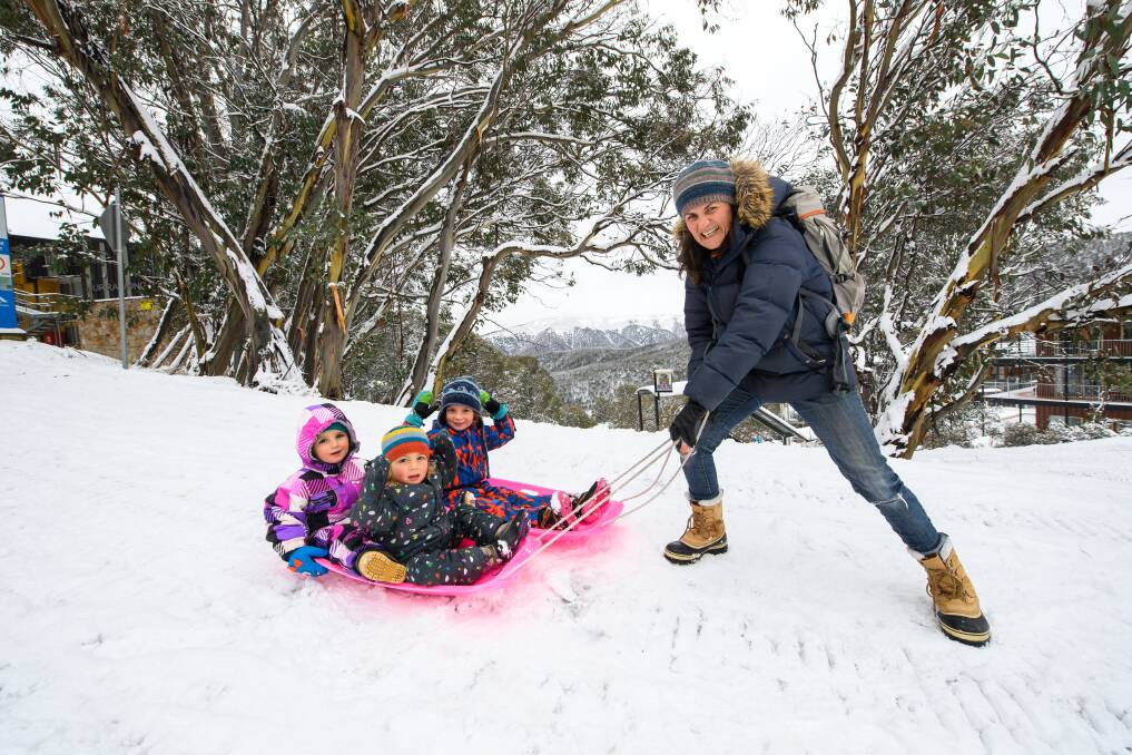 Hayley Seaton with her children, twins Vincent and Albert Roberts, both 2, and George, 5, at Falls Creek on Wednesday. Picture: MARK JESSER