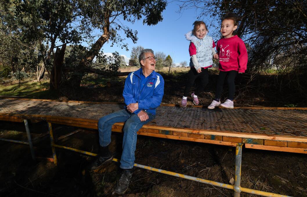 ACCESS: Yack Men's Shed's Frank Burfitt, Savannah Lockett, 5, and Grace Patterson, 4, try out the new boardwalk. Picture: MARK JESSER