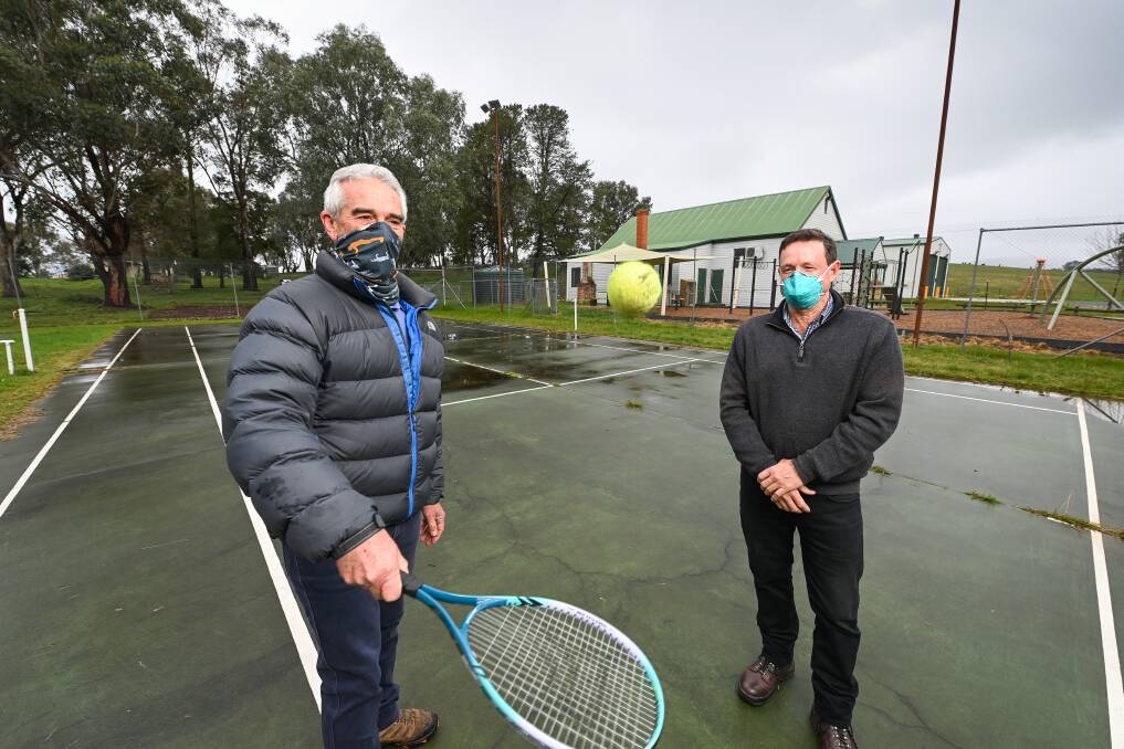 SUCCESS: Talgarno Recreation Reserve committee of management president David Cottee and Towong mayor David Wortmann are excited to see the reserve's tennis courts redone with a state government grant. Picture: MARK JESSER